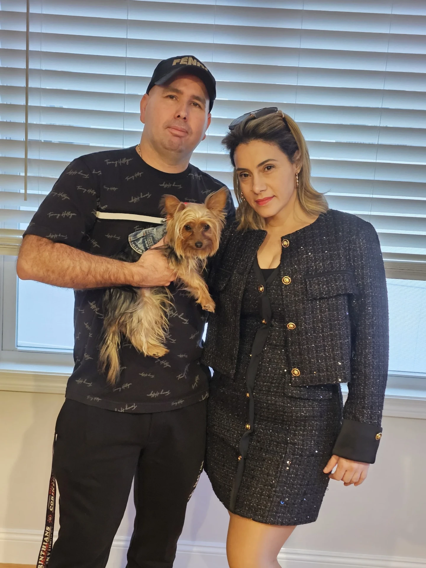 Débora Meireles with her family and Zoe, the Yorkshire Terrier, at home